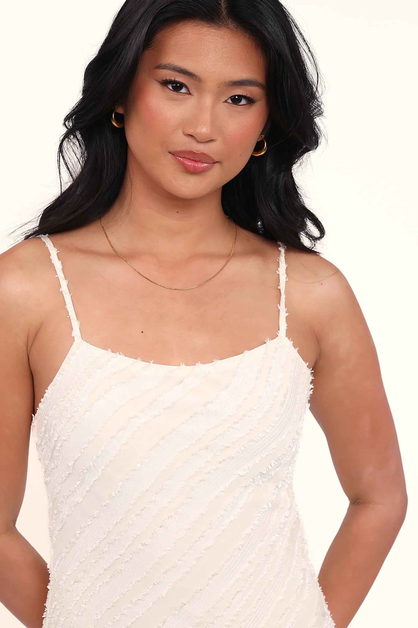 Thin adjustable straps on a cream bodycon midi dress