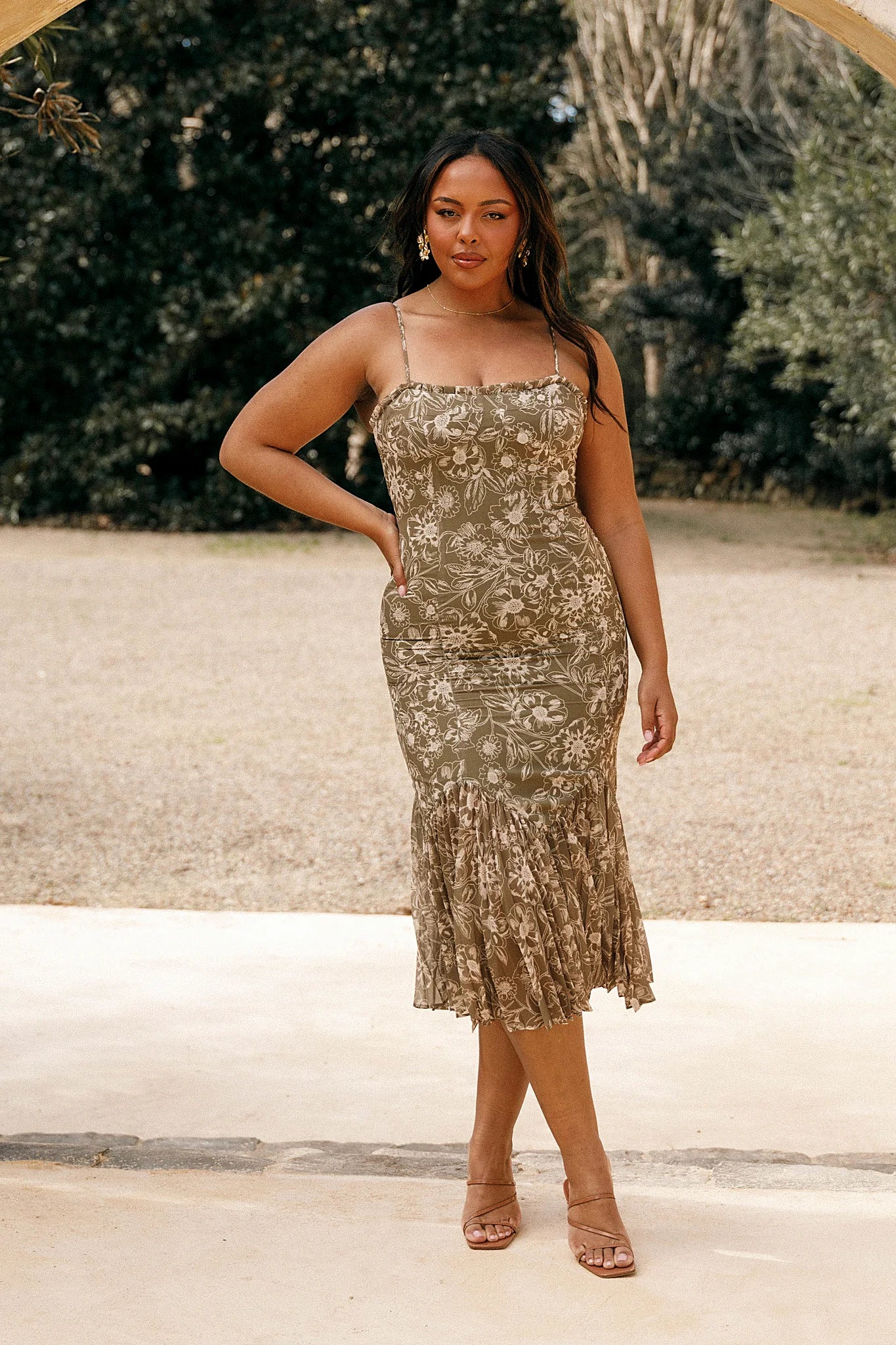 Shirred back panel on an olive floral midi dress