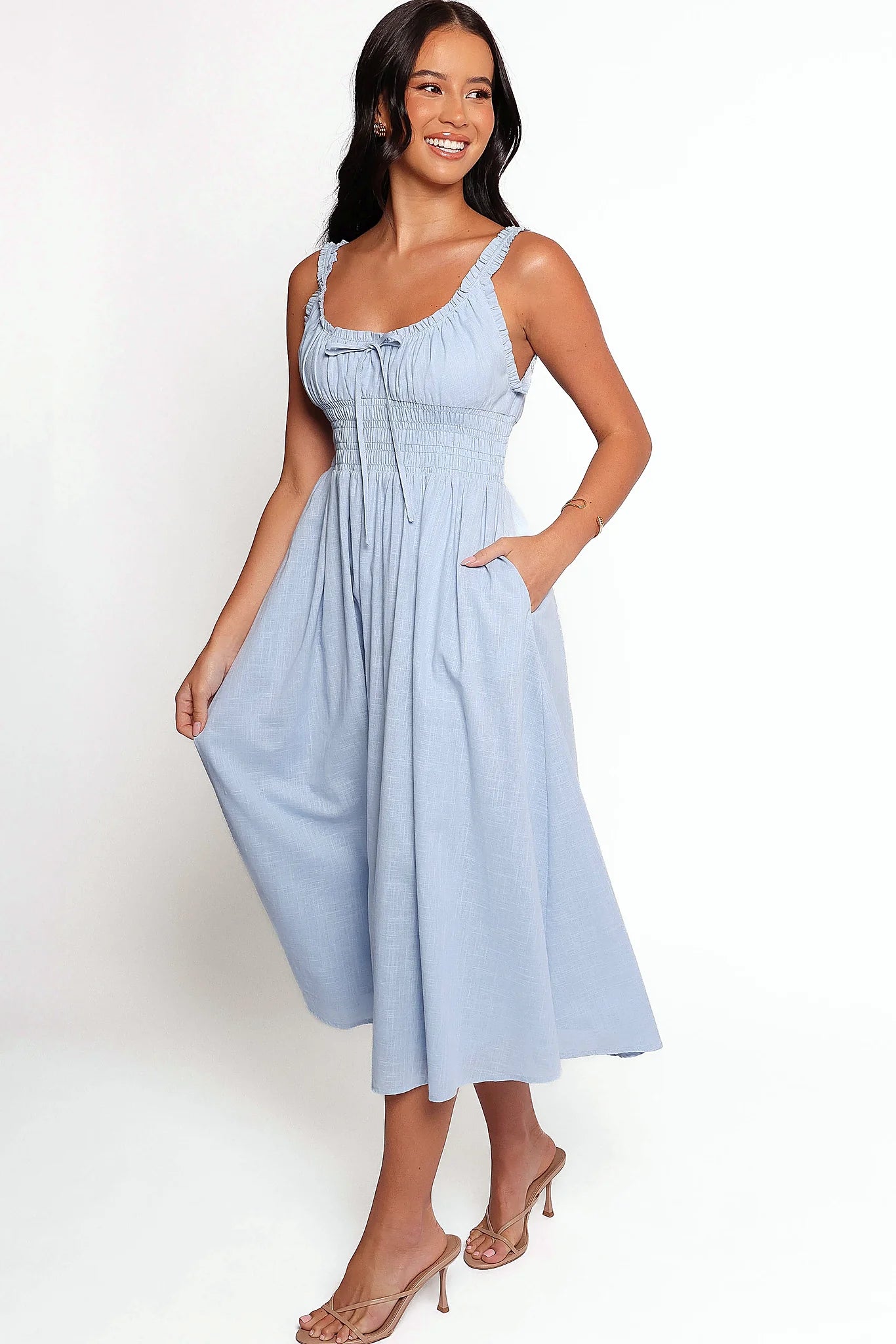 Full length view of a pale blue midi dress with pockets