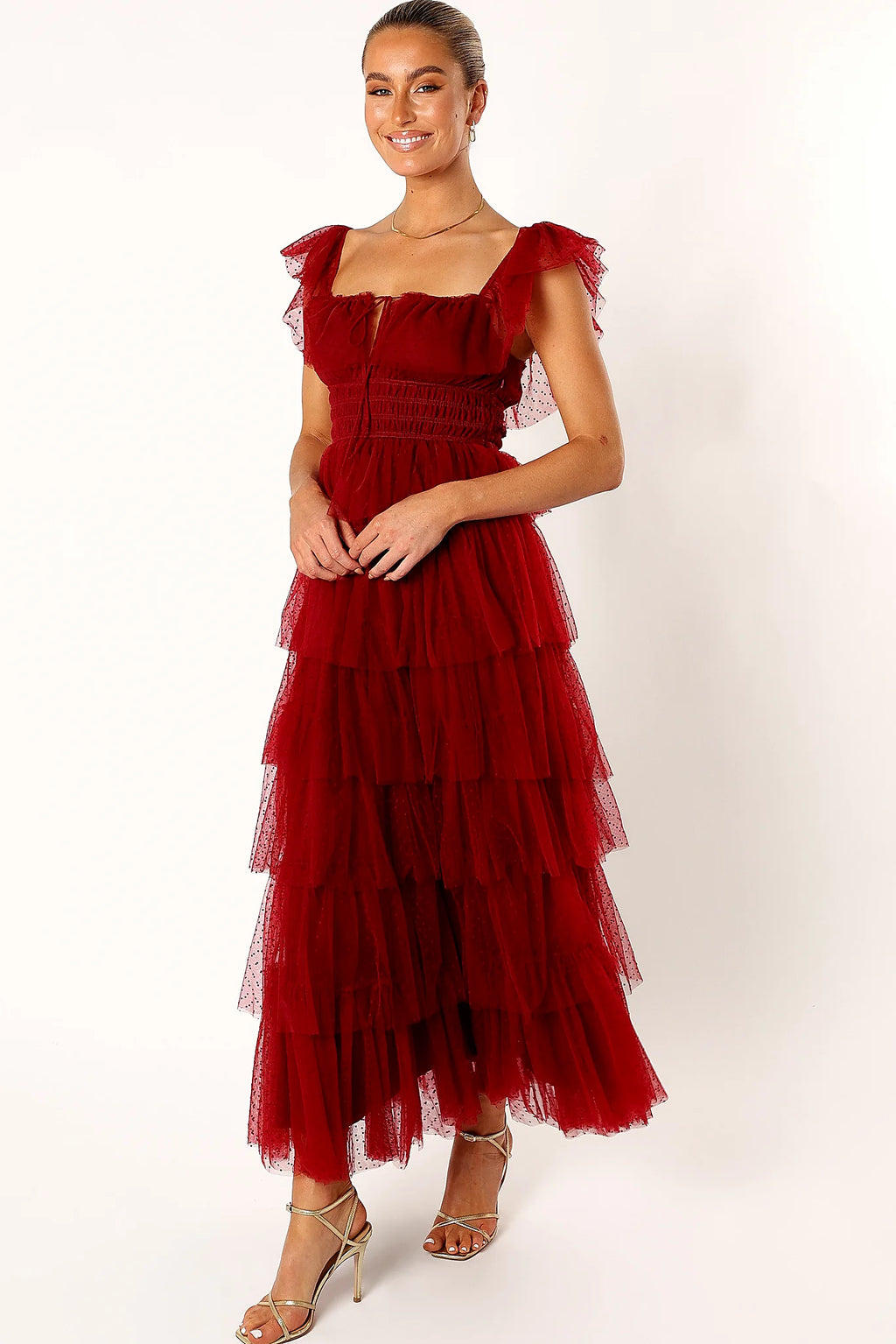 Full length view of a drop tiered burgundy tulle maxi dress