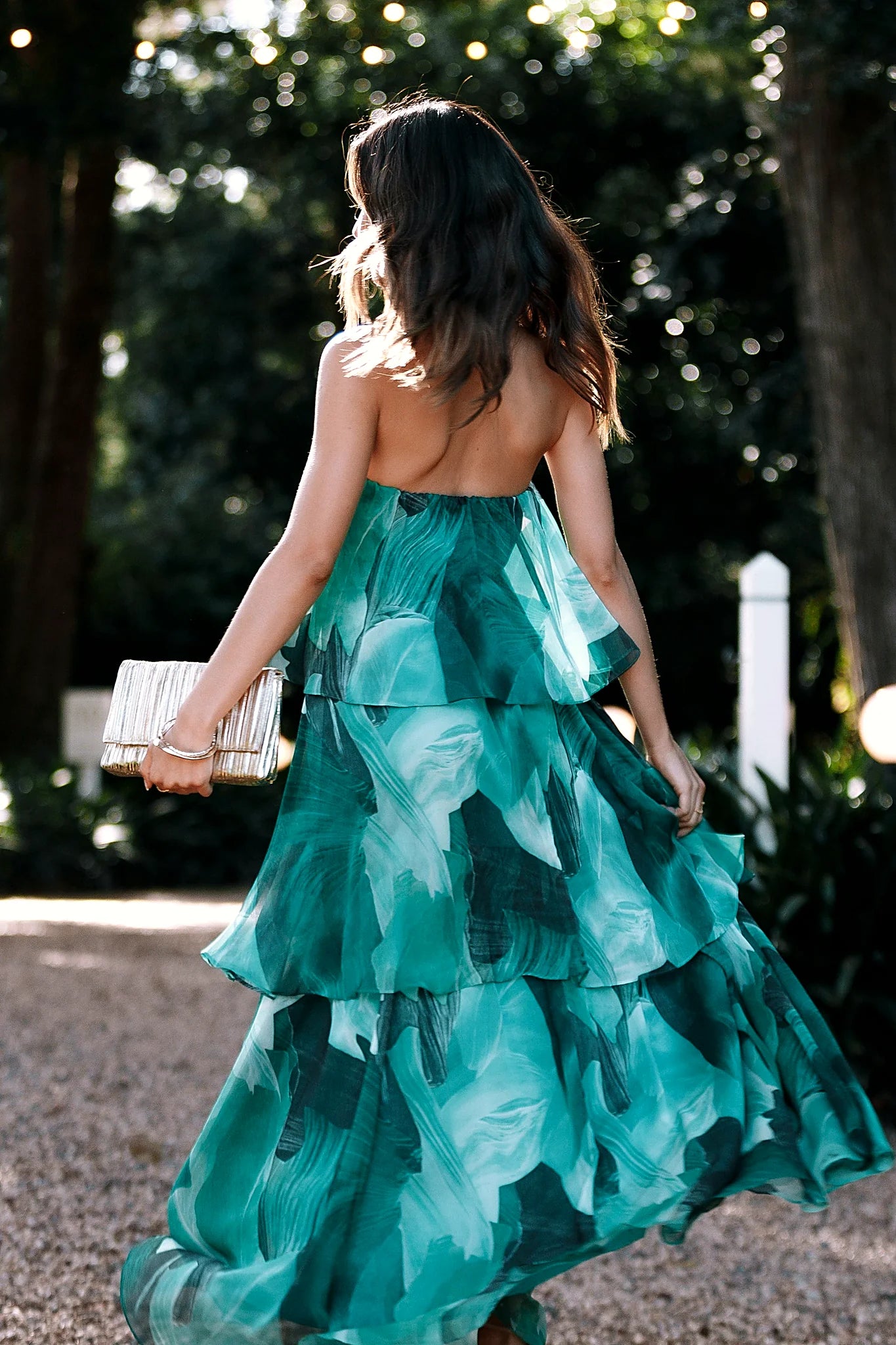 Elasticised straight neckline on a green strapless maxi dress