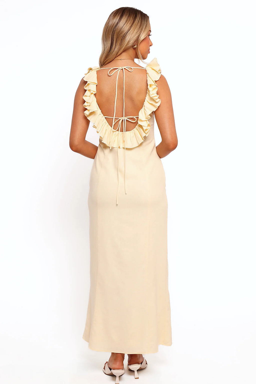 Low back design with ruffle frill on a yellow maxi dress