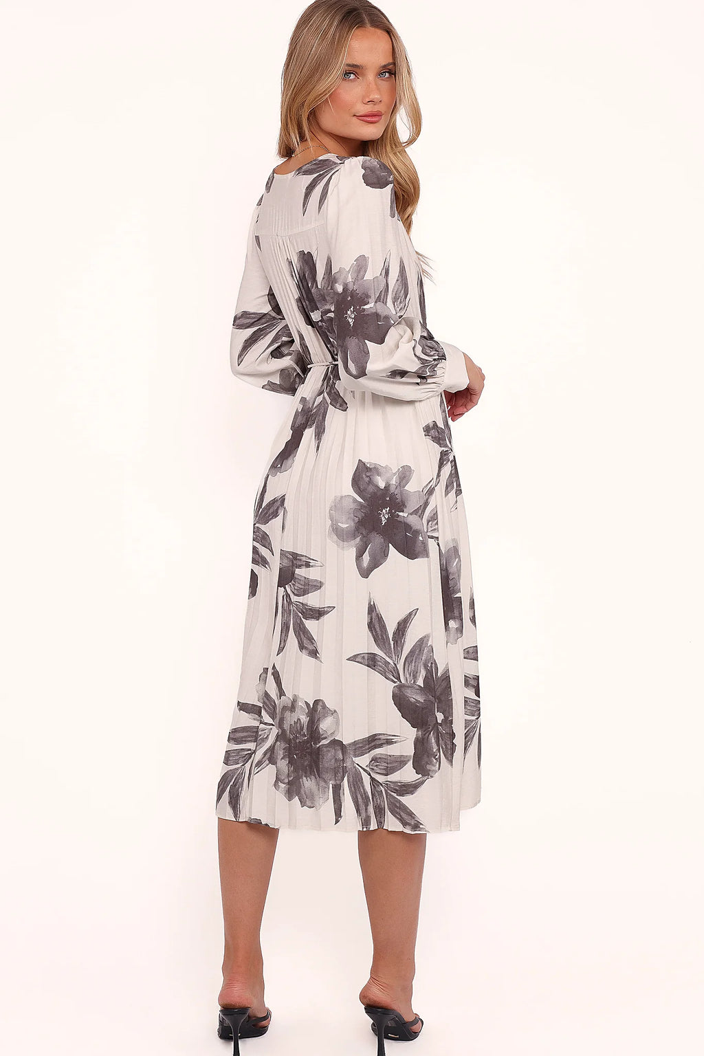 Full length view of a pleated black floral midi dress