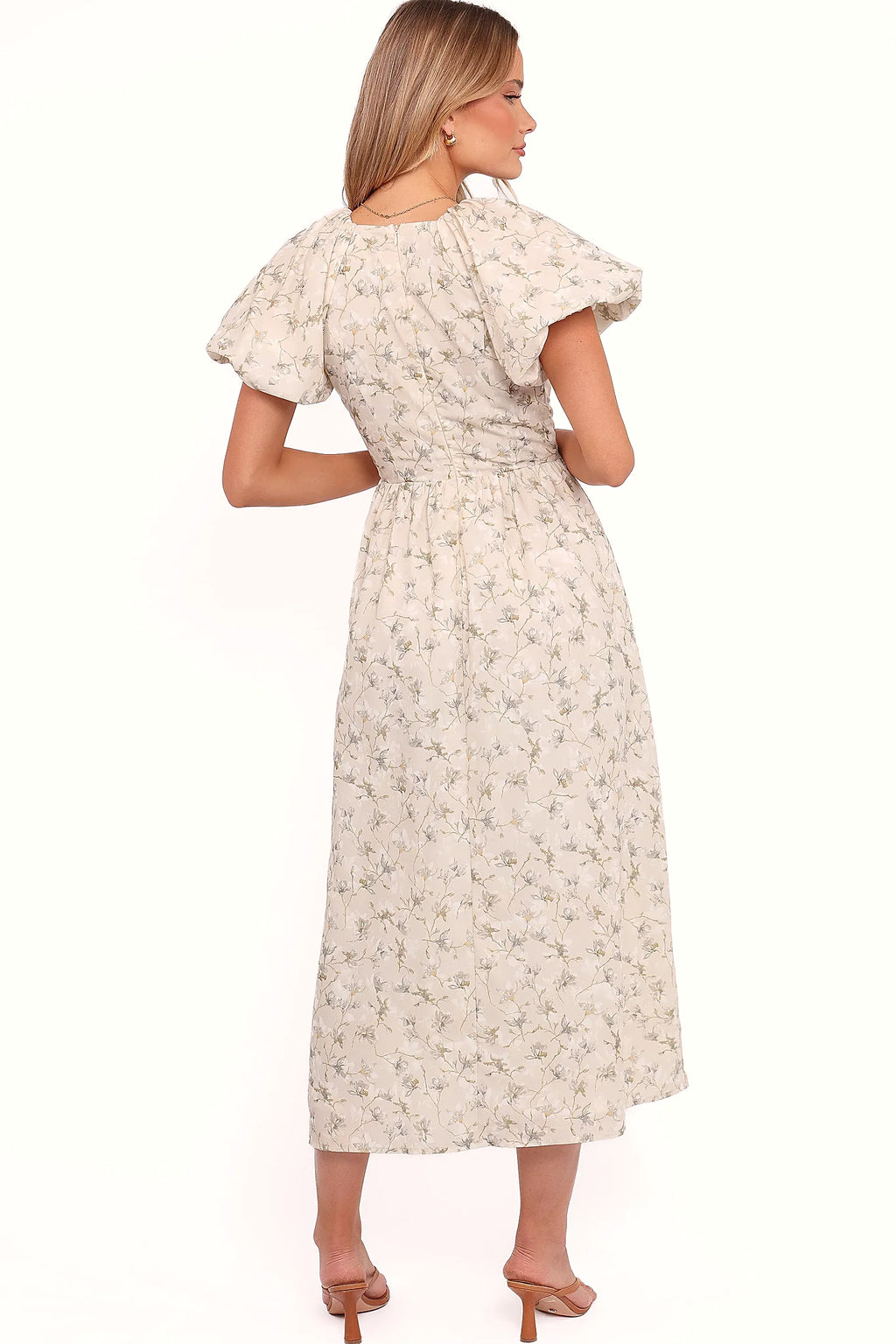 Full length view of a beige and green floral A-line maxi dress
