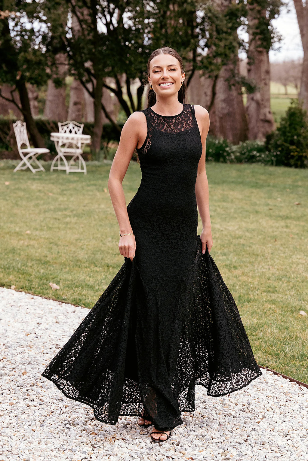 Black maxi dress with a floral lace overlay and boat neckline