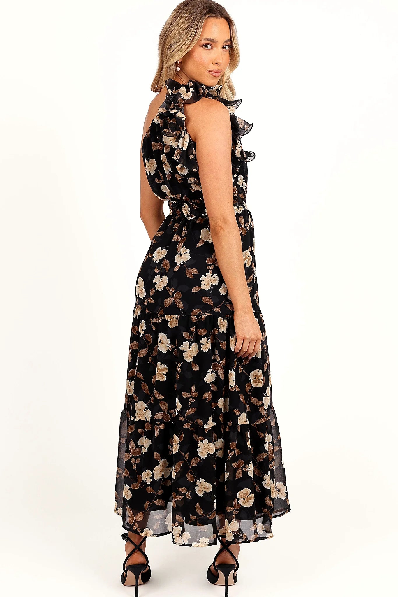 Full length view of a black floral drop tier maxi dress
