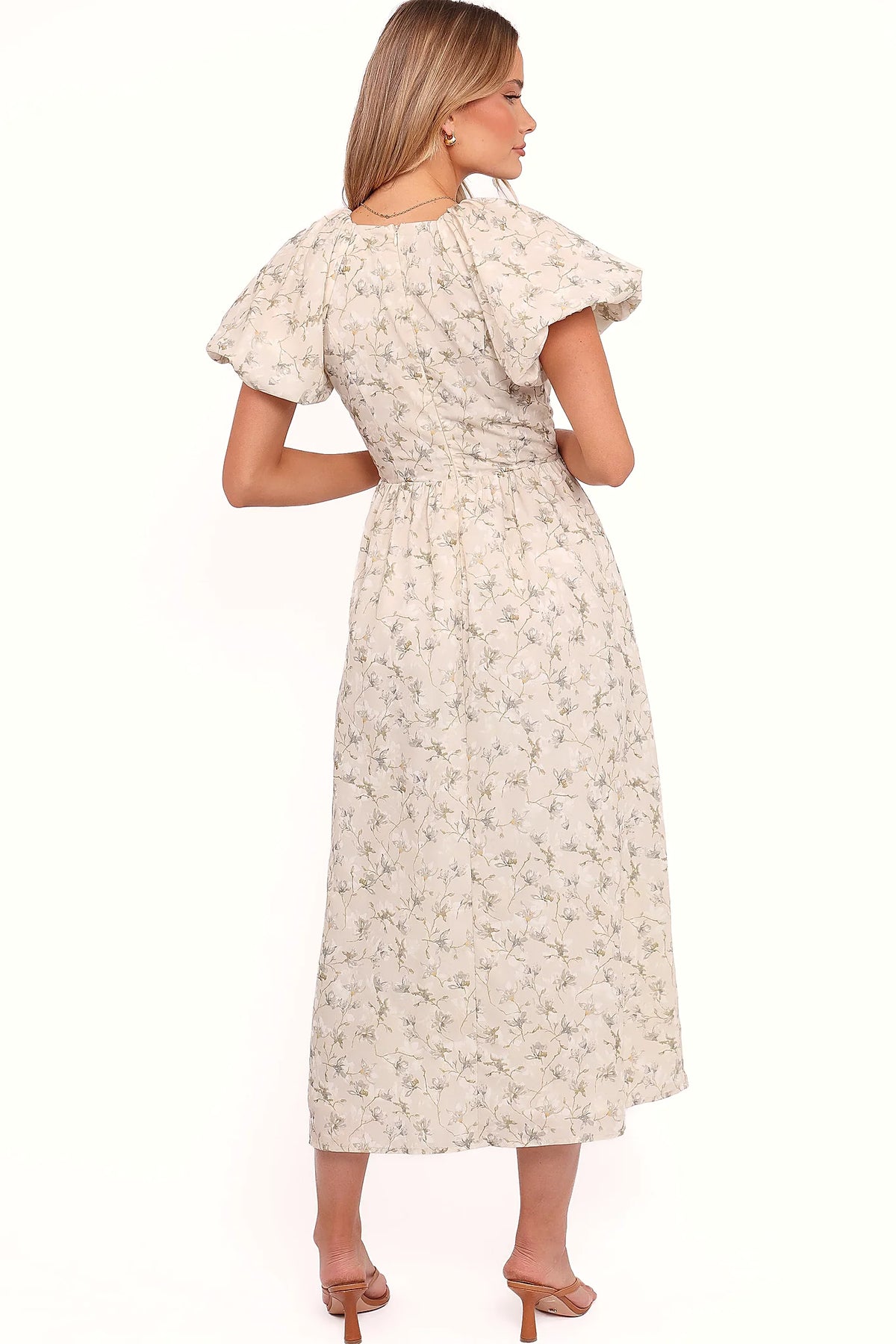 Full length view of a beige and green floral A-line maxi dress