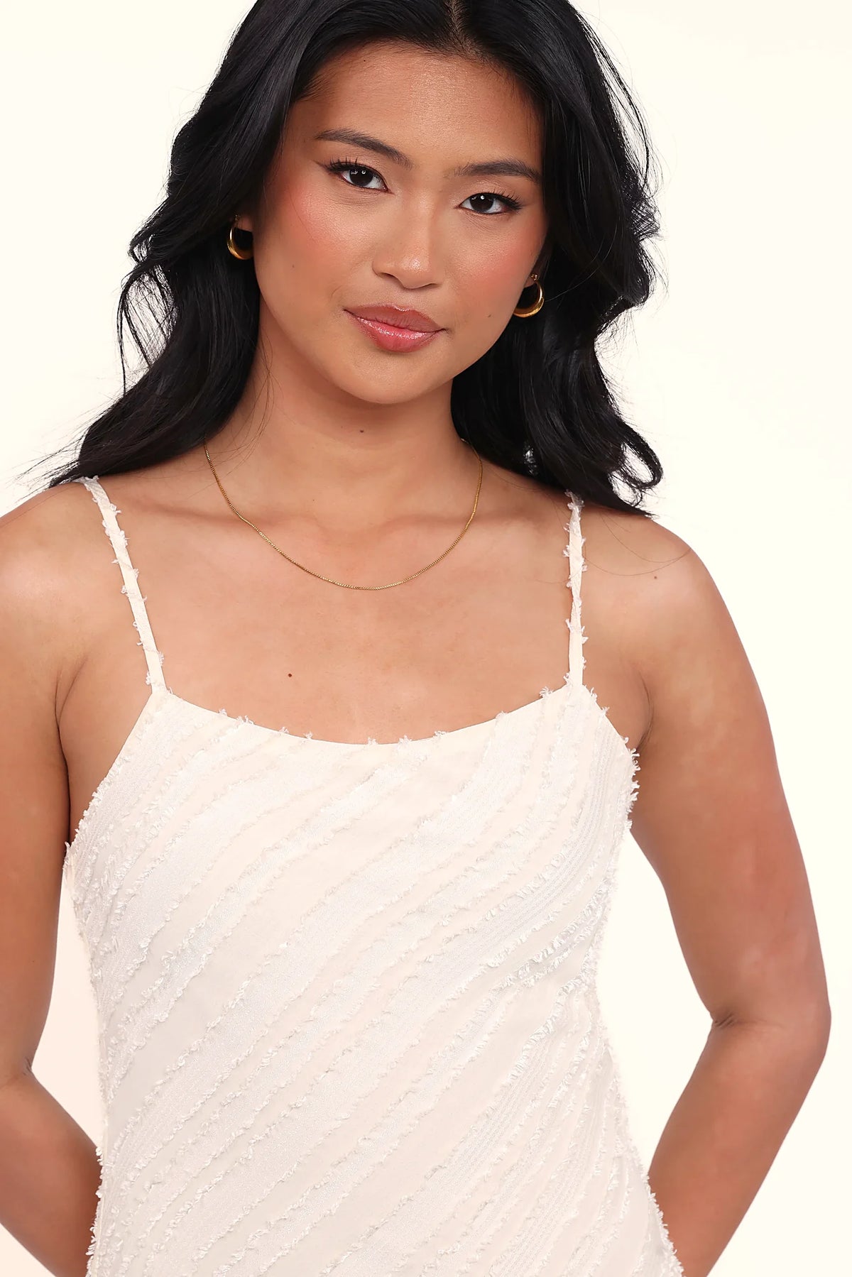 Thin adjustable straps on a cream bodycon midi dress