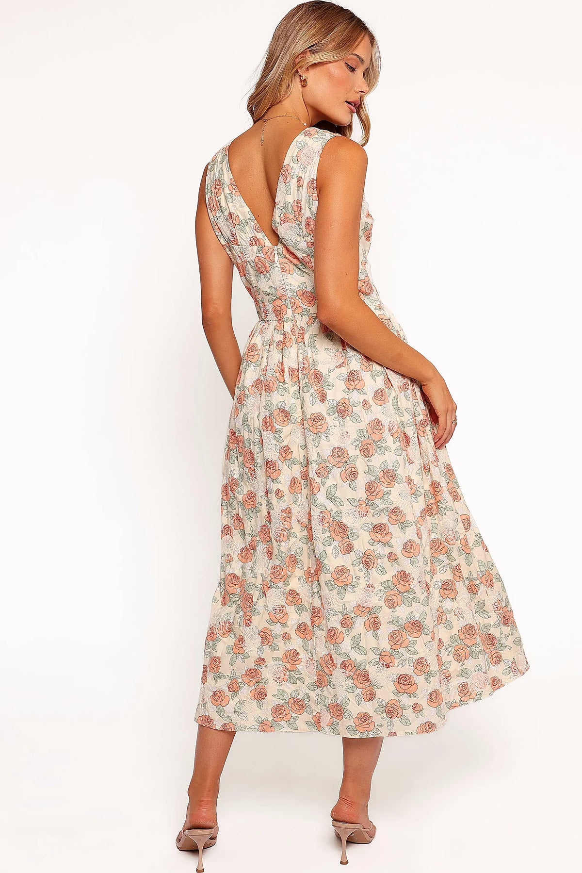 Full length view of a pink floral A-line midi dress