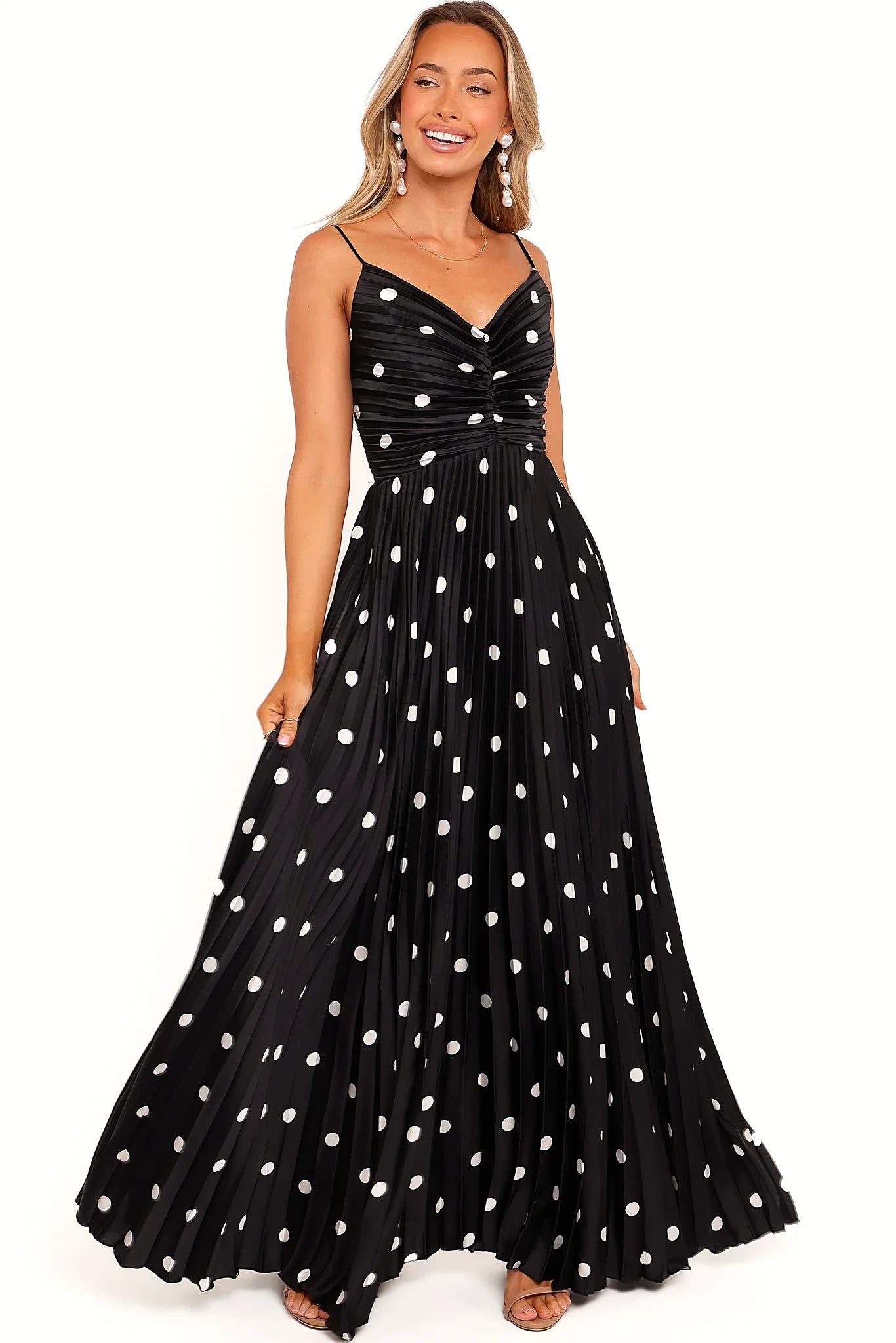Thin adjustable straps on a black polka dot maxi dress
