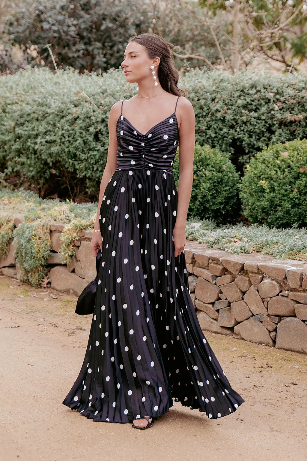 Black polka dot pleated maxi dress with a V neckline