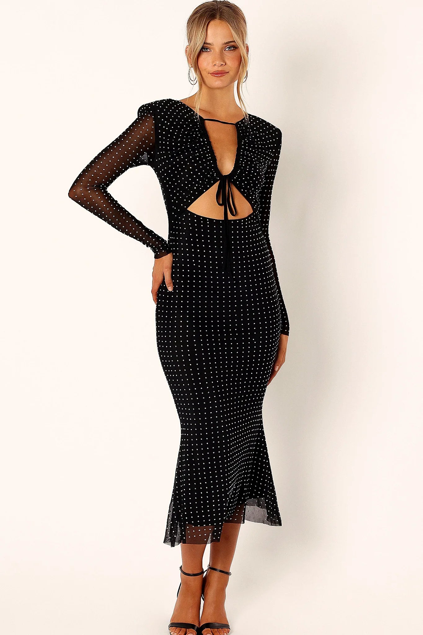 Cut out on the bust of a black sequin midi dress