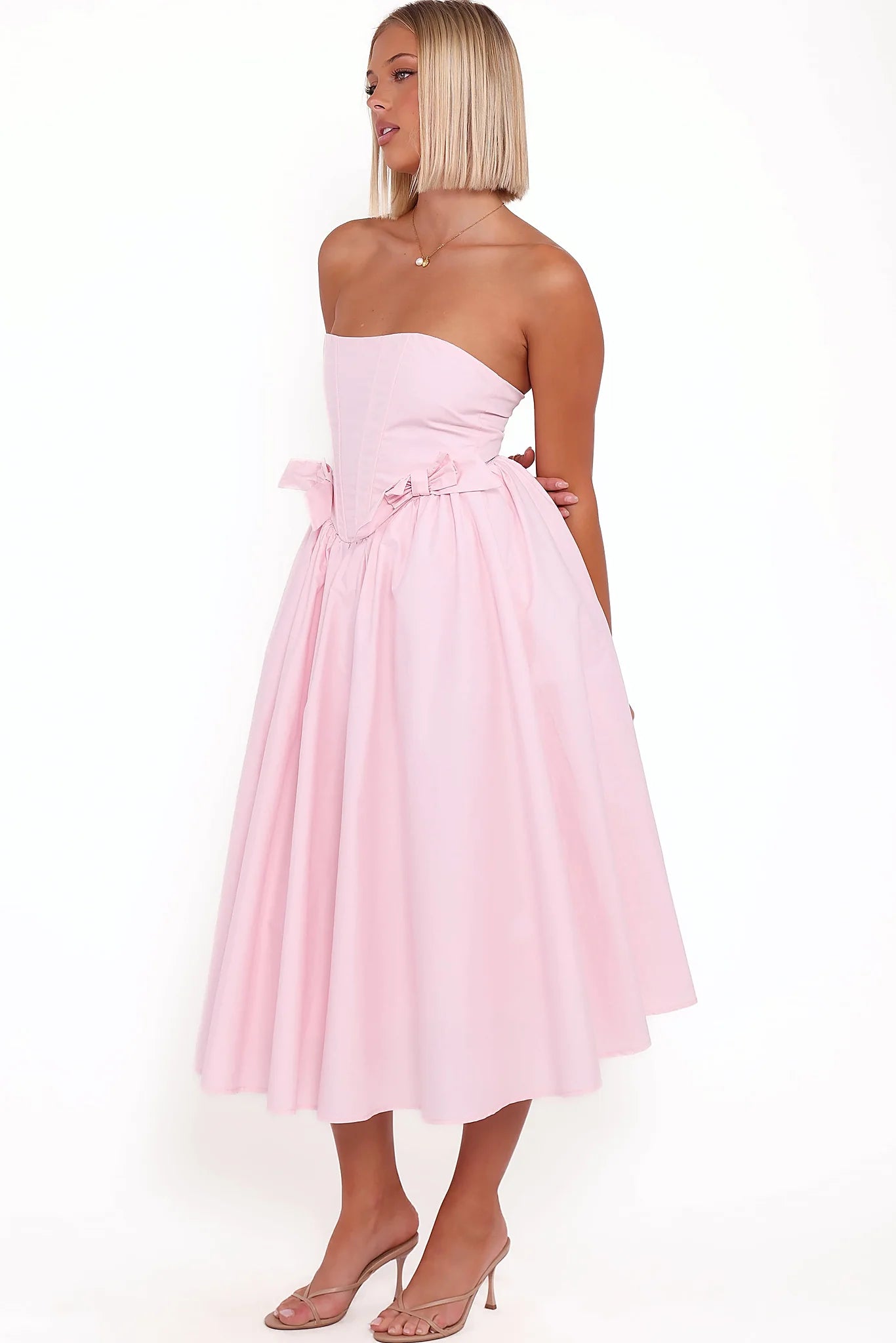 Tulle underskirt detail beneath a pink midi dress