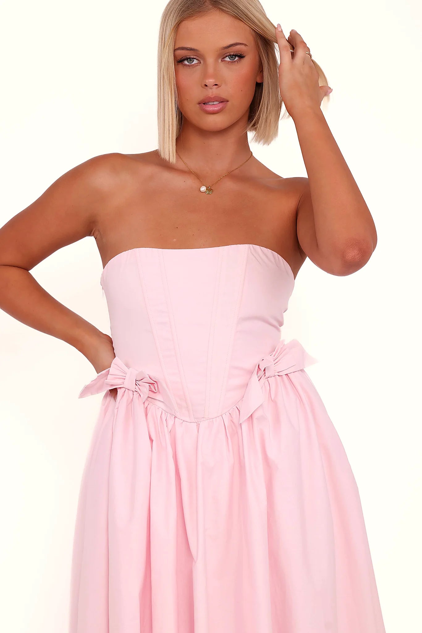 Corset tie close design at the back of a pink midi dress