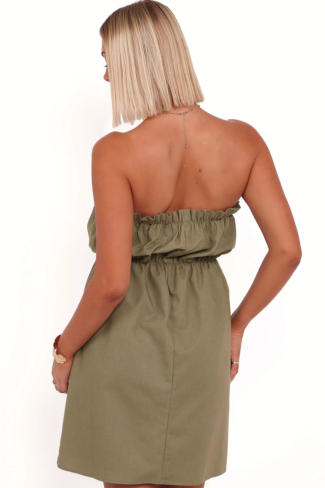 Full view of a leaf green strapless mini dress
