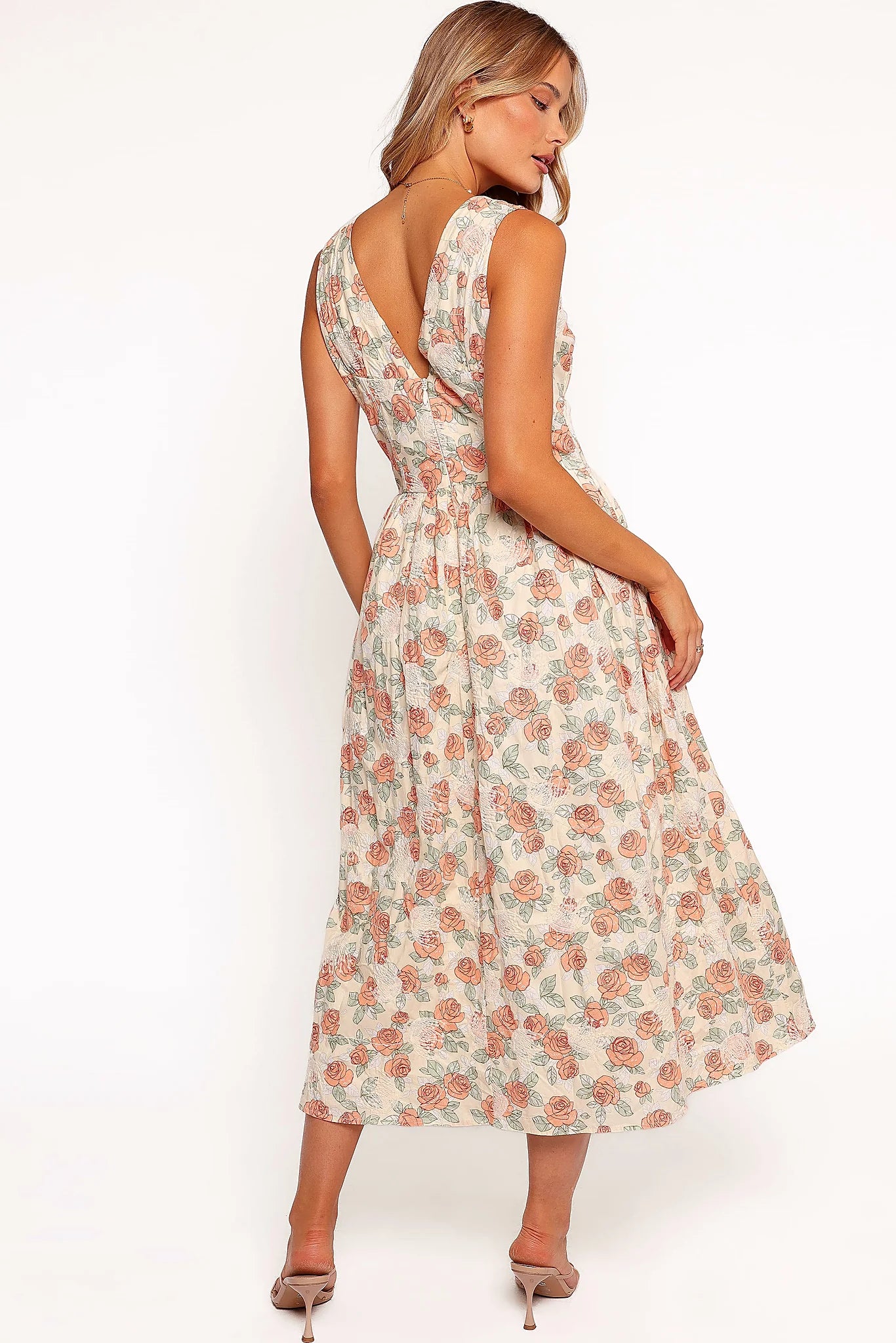 Full length view of a pink floral A-line midi dress
