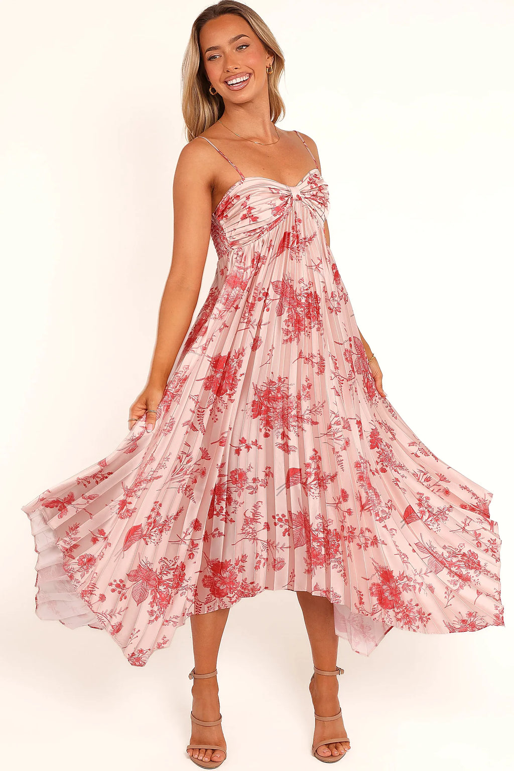 Asymmetrical hemline on a red floral satin dress